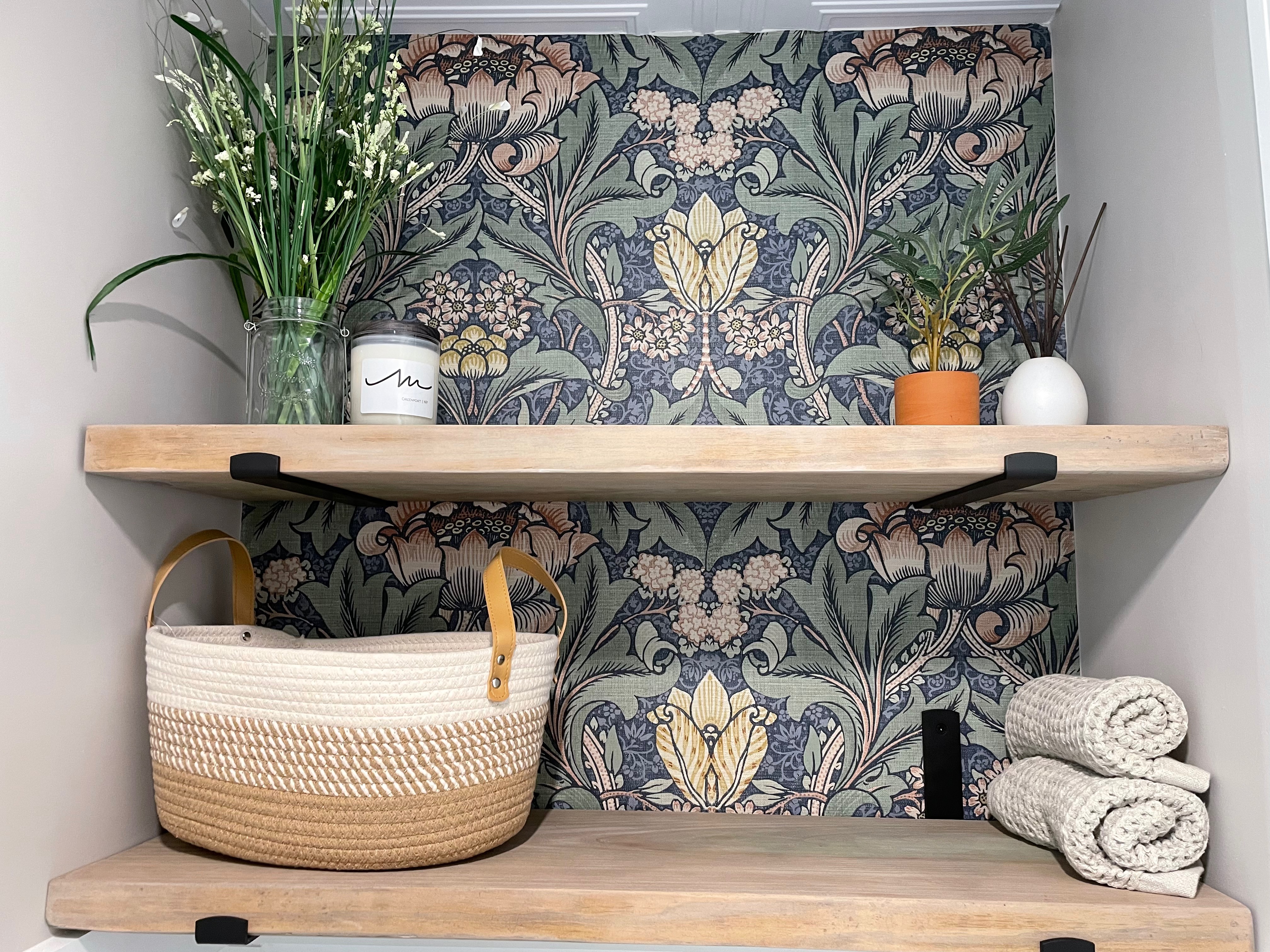 Toilet nook with wallpaper and shelves